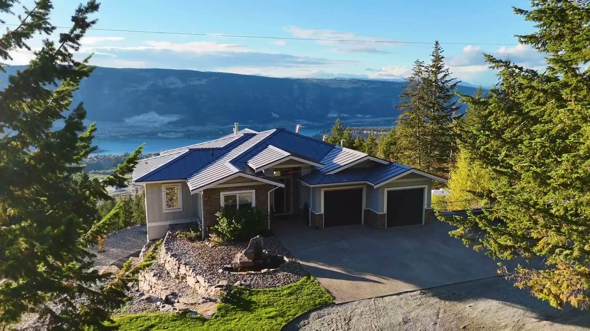 6022 Oyama Lake Road, Lake Country: front of the house at dusk above the valley